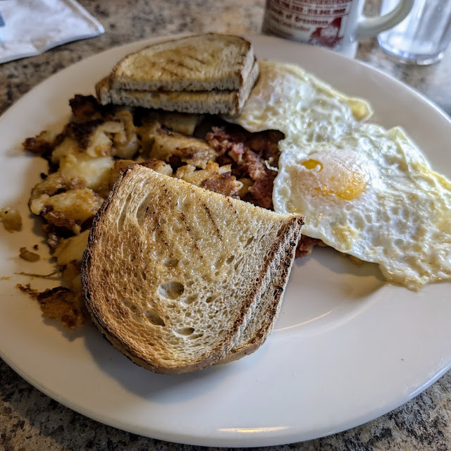 Eggs and Toast with Hashbrowns Bacon and Sausage