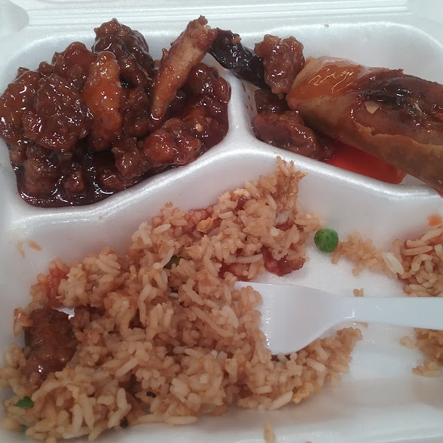 Orange Chicken with Rice Carrots Peas and a Vegetable Spring Roll