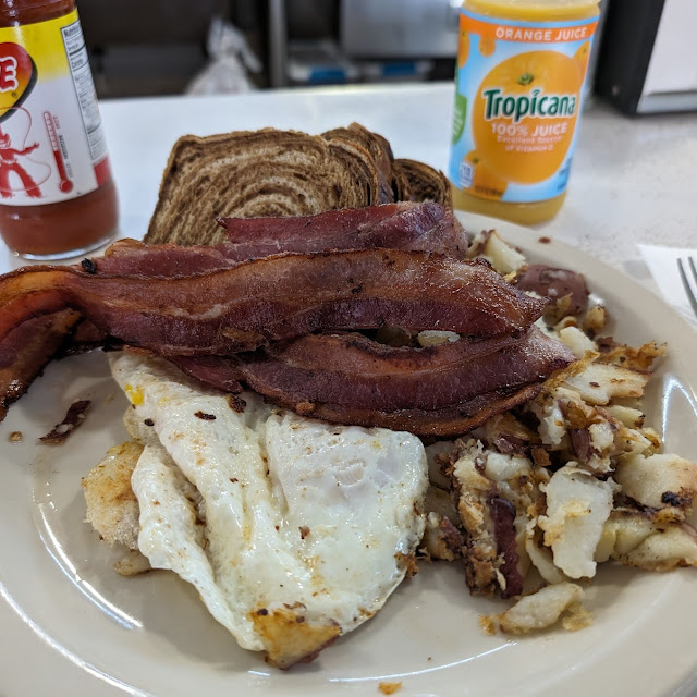 Eggs over Sausage Gravy on Home Fries Thick Bacon