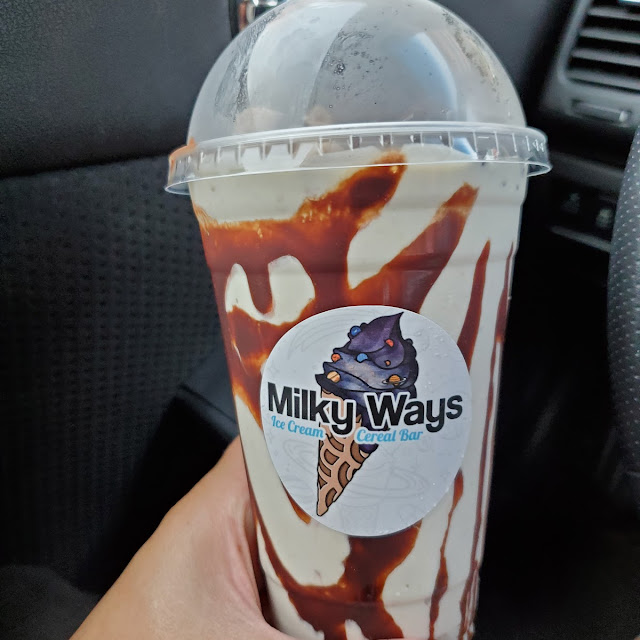 Vanilla Ice Cream Shake with Lucky Charms Cookie Dough Bites Brownie Bites and Chocolate Sauce