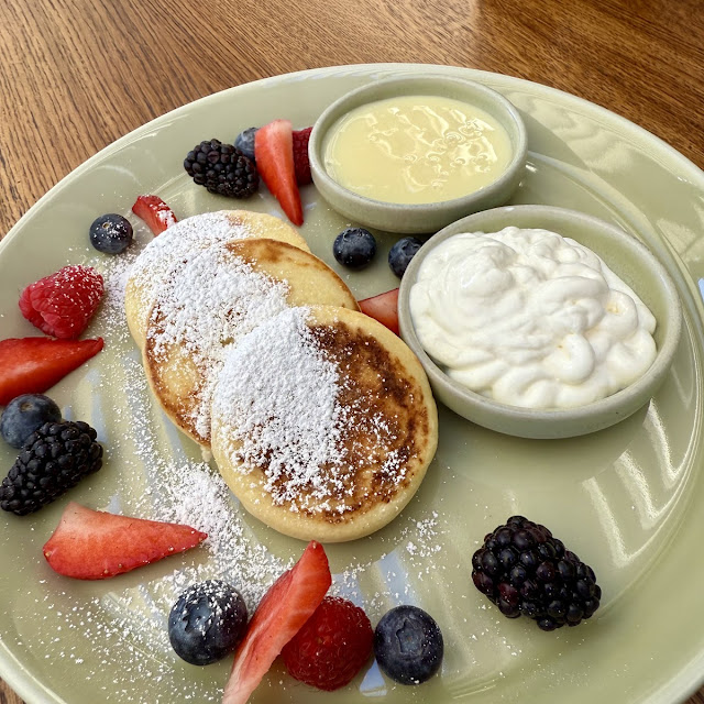 Syrniki with Mango Custard with Mango Custard and Berries