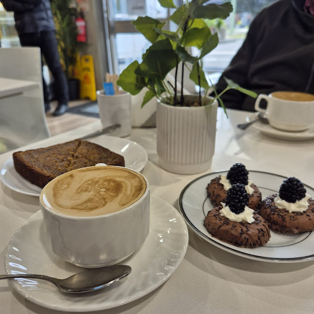 Banana Bread Flat White Coffee and Biscuits Covered with Chocolate with Cream and Raspberries