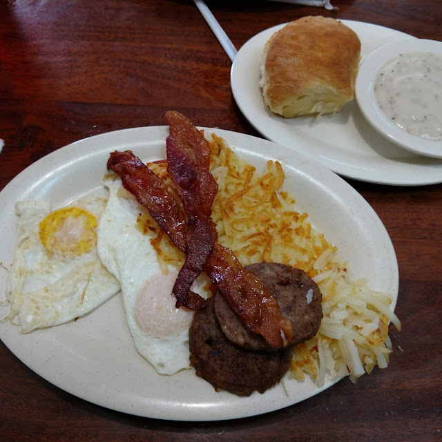 Two Eggs Two Bacon Two Sausage Patties with Hashbrowns and Biscuit with Side of Gravy