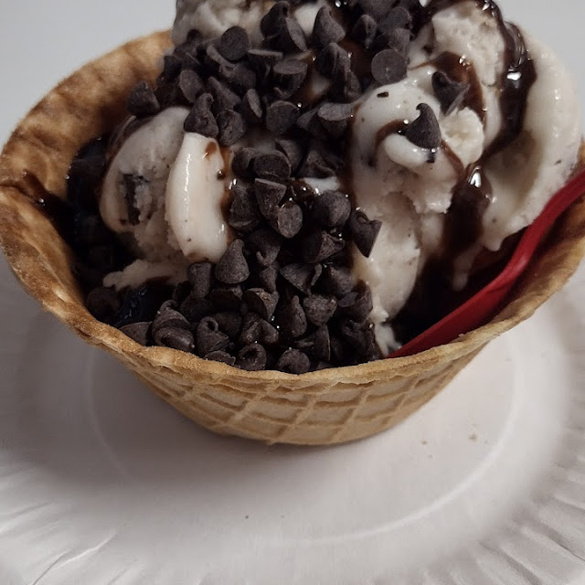 Hot Fudge Sundae in a Waffle Bowl Made with Oatmilk Ice Cream Topped with Mini Chocolate Chips