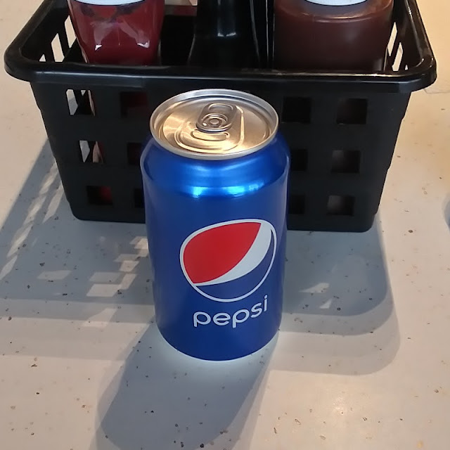 Pepsi Cola with Condiments Behind It