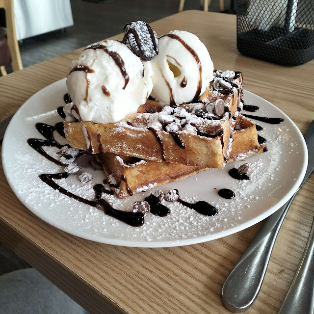 Chocolate Waffle with Chocolate Syrup Chocolate Chips and Maple Syrup