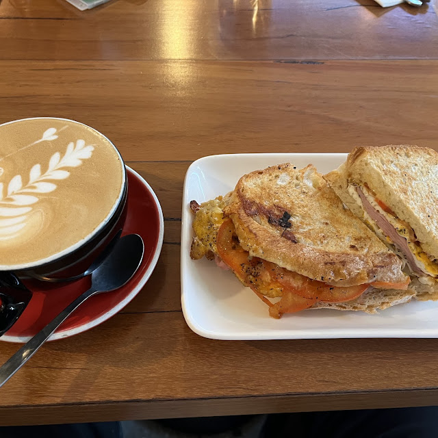 Strong Caffè Latte and Toasted Ham Cheese’S Tomato Egg Sandwich