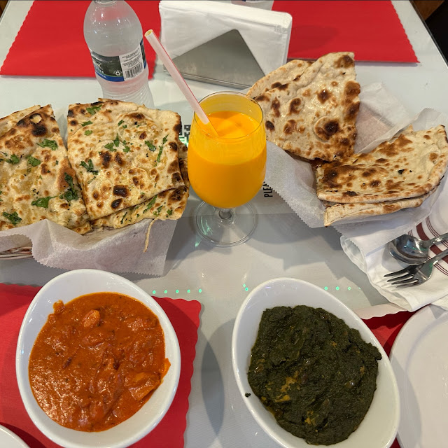 Palak Paneer and Butter Chicken and Naan and Mango Lassi