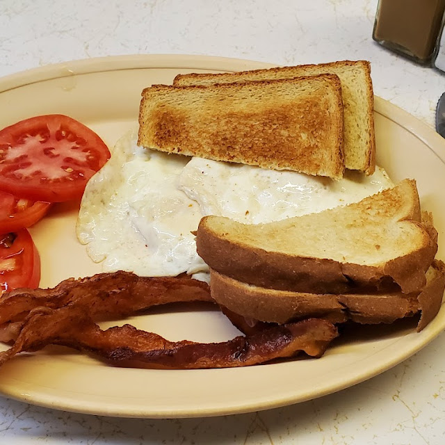 Eggs over Medium Crispy Bacon White Toast and Tomatoes Instead of Grits
